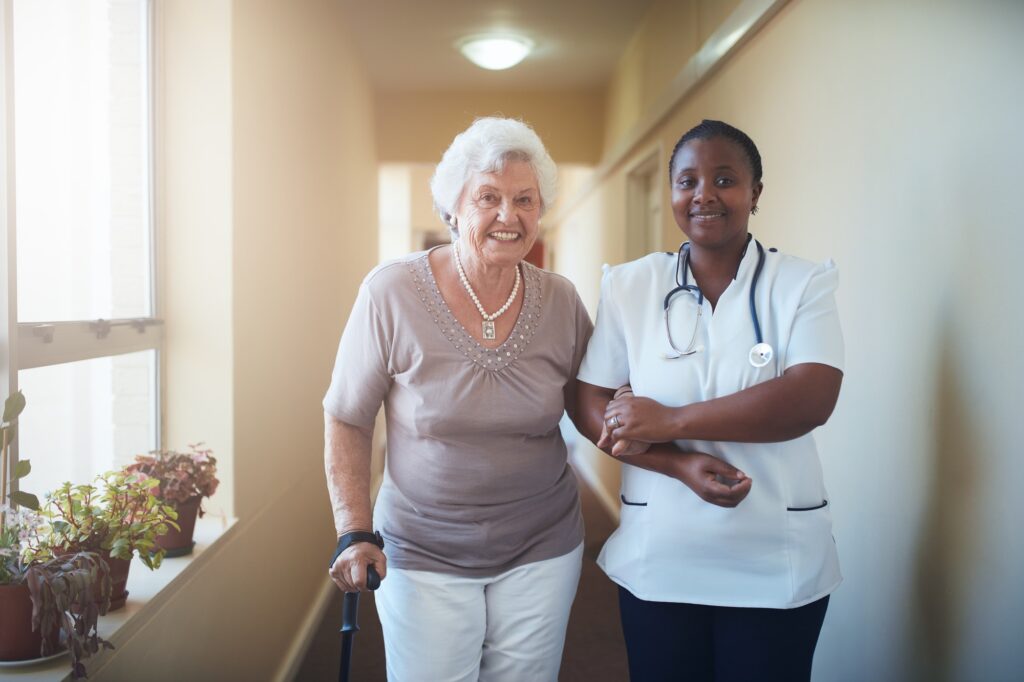 Nurse assisting a senior patient to walk